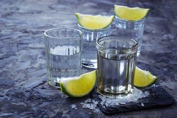 Shots of silver tequila with lime and salt