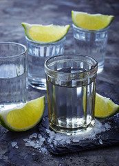 Shots of silver tequila with lime and salt