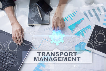 Woman is working with documents, tablet pc and notebook and selecting transport management.