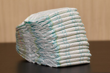 Stack of diapers or nappies on table, copyspace