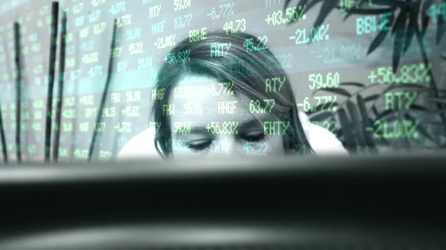 Woman investor overwhelmed at computer screen showing her stock values and investments plummeting
