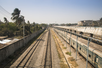 Fototapeta na wymiar Railroad tracks with a train in the station in Chittagong, the main port city of Bangladesh 