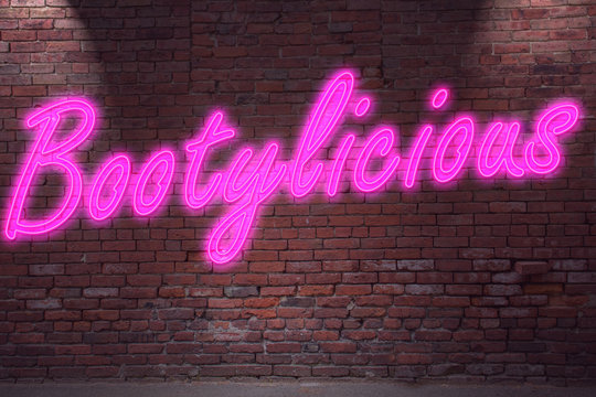 Leuchtreklame Bootylicious an Ziegelsteinmauer