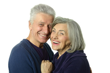 Happy old couple embracing on a white background