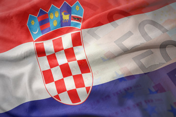 colorful waving national flag of croatia on a euro money banknotes background.