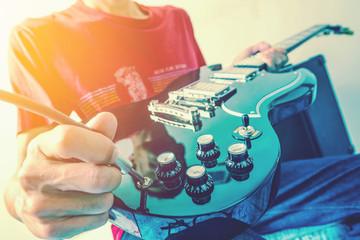 Close up shot of the man playing electric guitar
