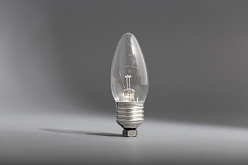 Electric light bulb on a gray background