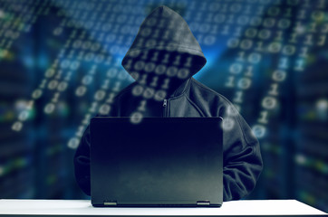 Hacker In Front Of Computer. Dark Face And Binary Code In Foreground. 