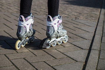 Children ride on inline skates on the street