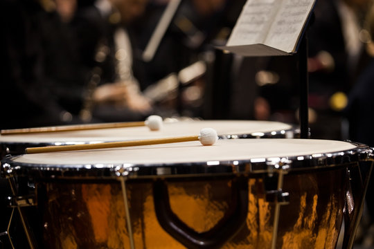  Drumsticks lying on timpani closeup in dark colors