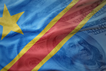 colorful waving national flag of democratic republic of the congo on a american dollar money background.