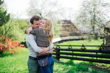 Happy young couple is hugging in the park