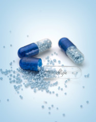 Blue capsules and pills background