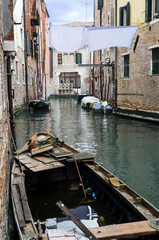 canal view in venice with a boat, view of a traditional canal in venice with boat. italy.