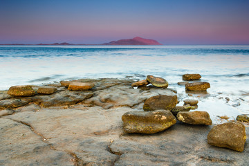 Landscape of Red Sea coastline at sunset. View of Tiran island on the horizon. Sharm El Sheikh. Egypt.  Effects  a long exposure shot.