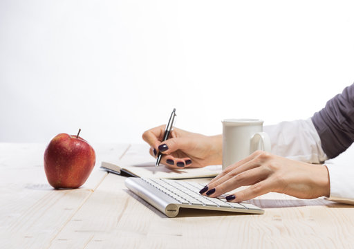 Business woman in an office holding red apple - Clipping Path