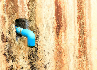 A pipe blue on wall old