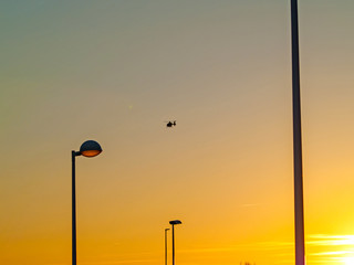 Sunset on a city and Streetlights and an helicopter