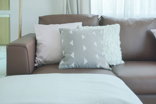 Close up pillows on brown sofa in the living room
