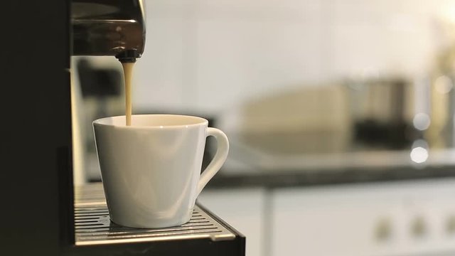 Coffee machine making espresso.