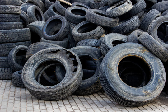 Waste of used car tires in the tire repair shop yard.