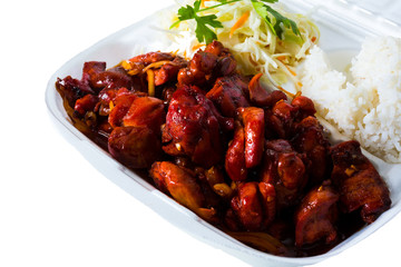 Vietnamese cuisine. meat, fried. packed in a box, disposable tableware. concept of fast food takeaway. Asian meat. Convenient but unhealthy polystyrene lunch boxes with take away meal on wooden table