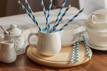 Set of white empty tableware with striped tubules