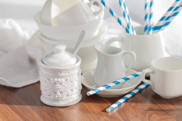 Set of white empty tableware with striped tubules