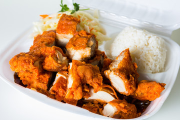 Vietnamese cuisine. meat, fried. packed in a box, disposable tableware. concept of fast food takeaway. Asian meat. Convenient but unhealthy polystyrene lunch boxes with take away meal on wooden table