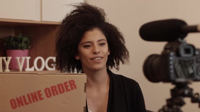 Vlogger shooting product review of her online order