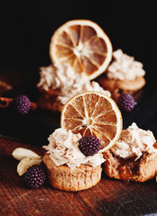 almond and orange cupcake with fresh blackberry