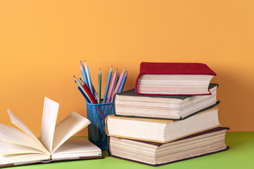 Open book, hardback bookson bright colorful background.