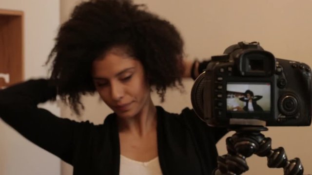 Influencer fixing hair for shooting video