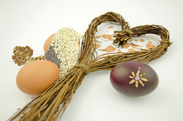 Still life with a heart of willow, Easter eggs and bird silhouette isolated on white background