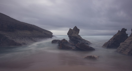 Amazing Wild rock beach in a stormy day Sintra Cascais Natural Park Portugal. 