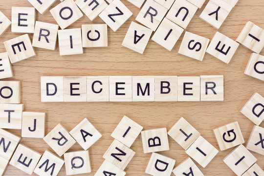 December words with wooden blocks on wooden floor..