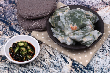 Steamed Dumpling stuffed with garlic chives with spicy soy source.