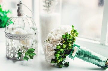 luxurious bridal bouquet of white peonies on the windowsill in front of the window.