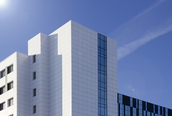 High-rise glass building against blue sky