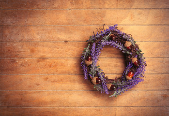 photo of cute lavender wreath with nuts on the wonderful brown wooden background