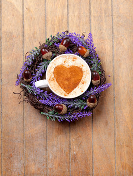 photo of cute lavender wreath with nuts and cup of coffee on the wonderful brown wooden background