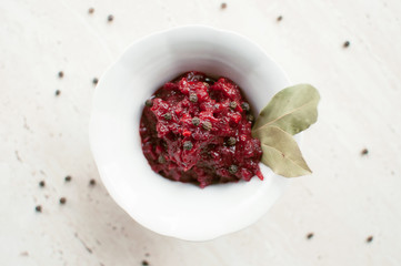 Homemade tomato sauce with bay leaf in the white bowl