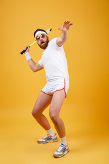 Fototapeta na wymiar Vertical image of funny sportsman playing in tennis