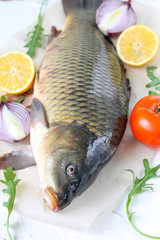  carp with lemon and tomato - fresh river fish