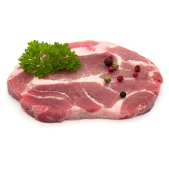 Raw pork neck chop meat with parsley herb leaves and peppercorn spices garnish isolated on white background cutout