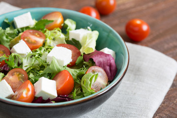 Salad with cherry tomatoes, Radicchio lettuce, frize, arugula and feta