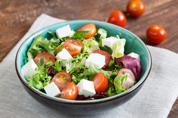 Salad with cherry tomatoes, Radicchio lettuce, frize, arugula and feta