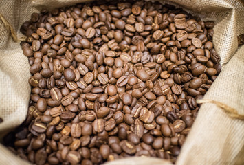 Roasted coffee beans in small sack