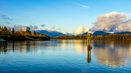 Sunset over the Fraser River near Fort Langley in the middle of winter with the snow covered Coastal Mountains in the background
