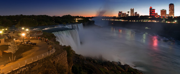 Fototapeta premium Niagara Falls lit at night show by colorful lights. American waterfall